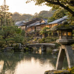雪吊りの松と石灯籠がある兼六園風の庭園と金沢の茶屋建築をイメージした風景