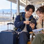 国内旅行保険をスマートフォンで確認する日本人旅行者