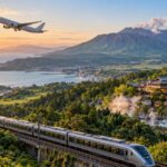 九州の火山と温泉街を背景に飛ぶ旅客機と走る列車
